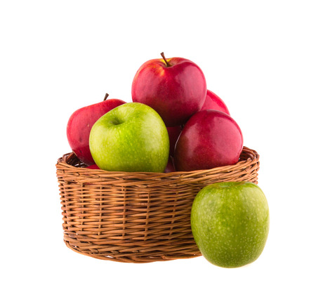 27362990 - red and green apples in a wooden basket on white background.